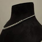 Elegant round cut diamond necklace set displayed on a black mannequin stand.