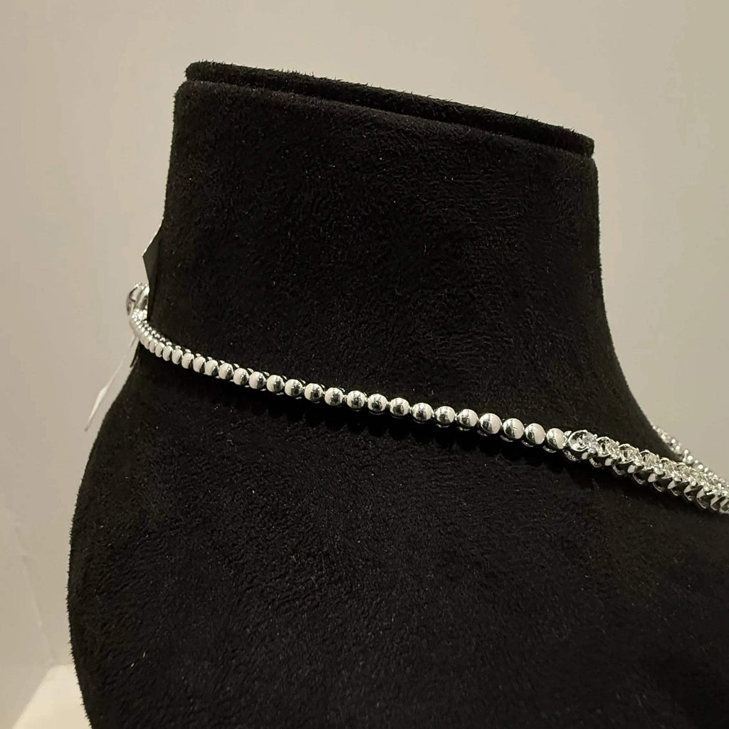 Elegant round cut diamond necklace set displayed on a black mannequin stand.