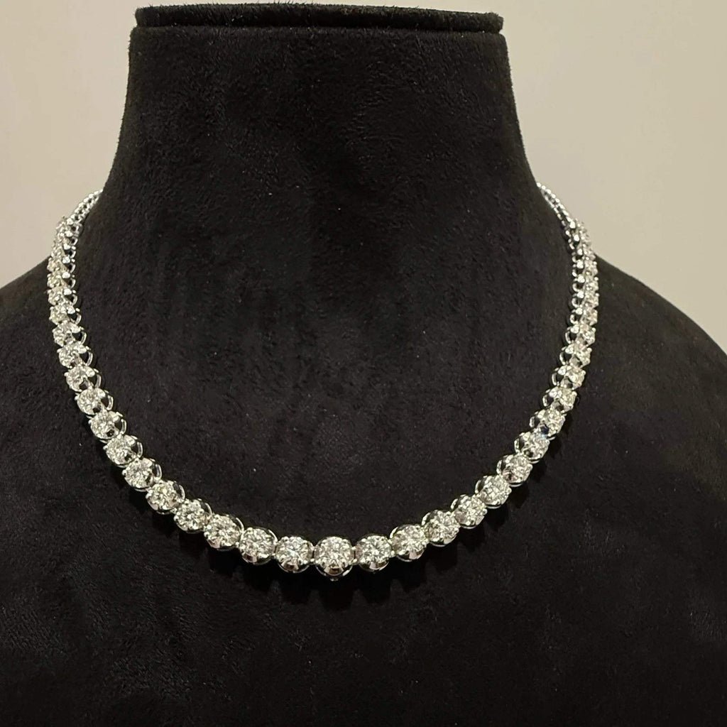 Elegant round cut diamond necklace set displayed on a black mannequin stand.