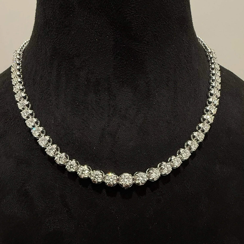 Elegant round cut diamond necklace set displayed on a black mannequin stand.