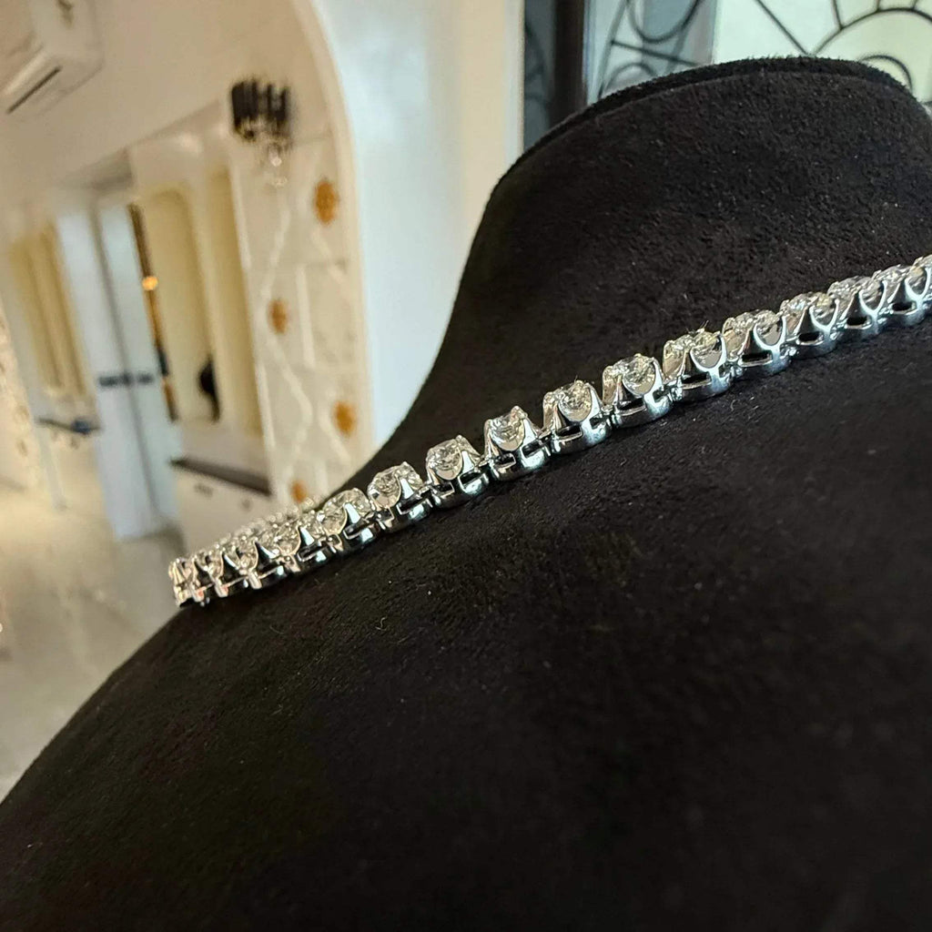 Side view of luxury diamond necklace set with prong-set round cut diamonds