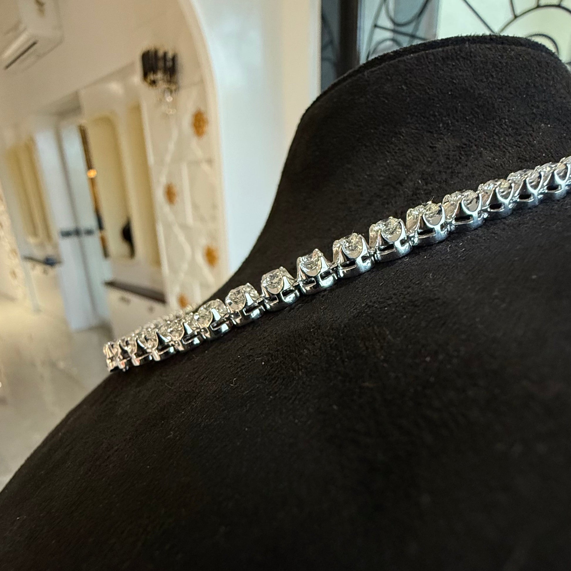 Side view of luxury diamond necklace set with prong-set round cut diamonds