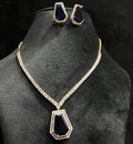 A gold diamond necklace with a geometric pattern and a pair of matching earrings, displayed on a black mannequin bust.