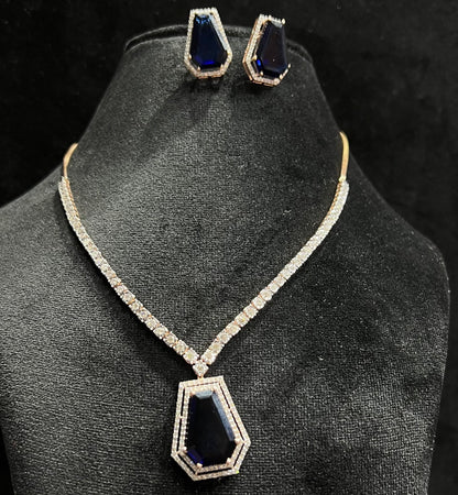 A gold diamond necklace with a geometric pattern and a pair of matching earrings, displayed on a black mannequin bust.