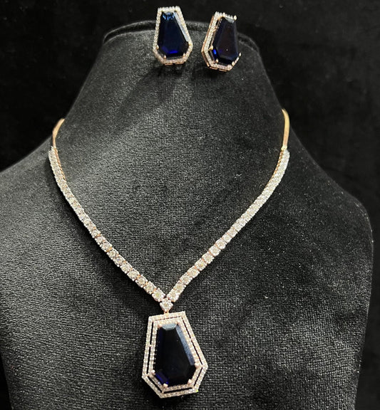 A gold diamond necklace with a geometric pattern and a pair of matching earrings, displayed on a black mannequin bust.