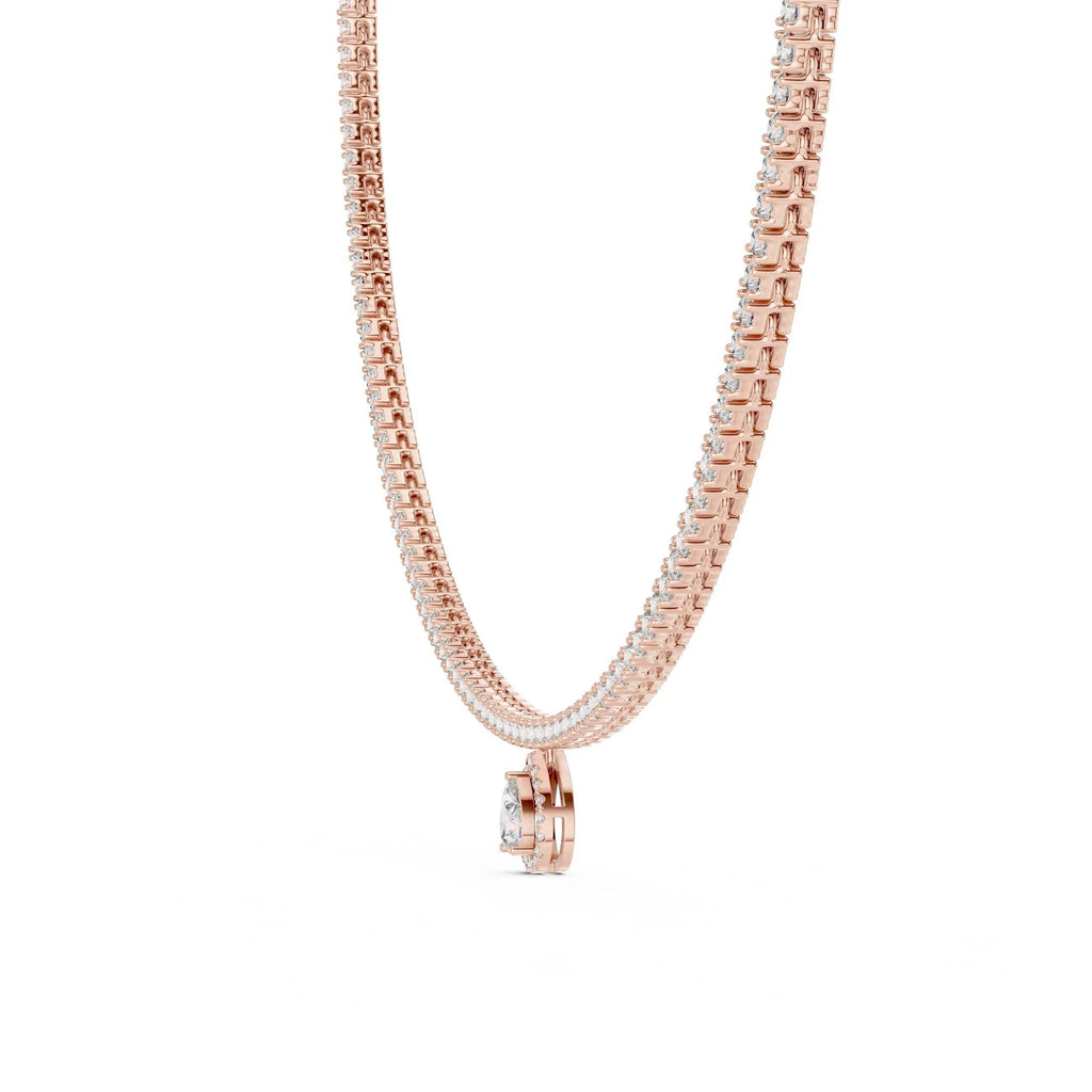 Gold and diamond tennis necklace with a small pear shape diamond pendant on a white background