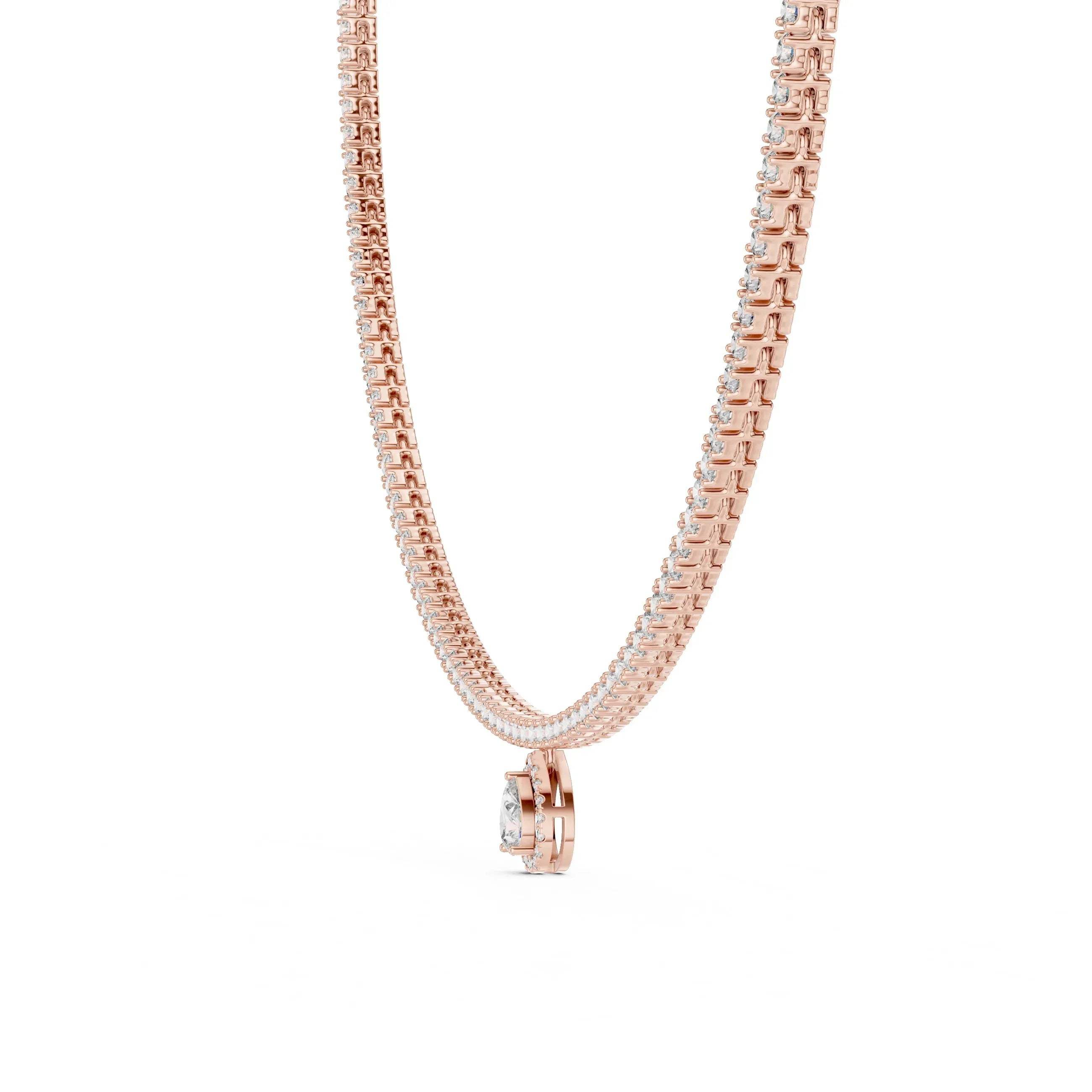 Gold and diamond tennis necklace with a small pear shape diamond pendant on a white background