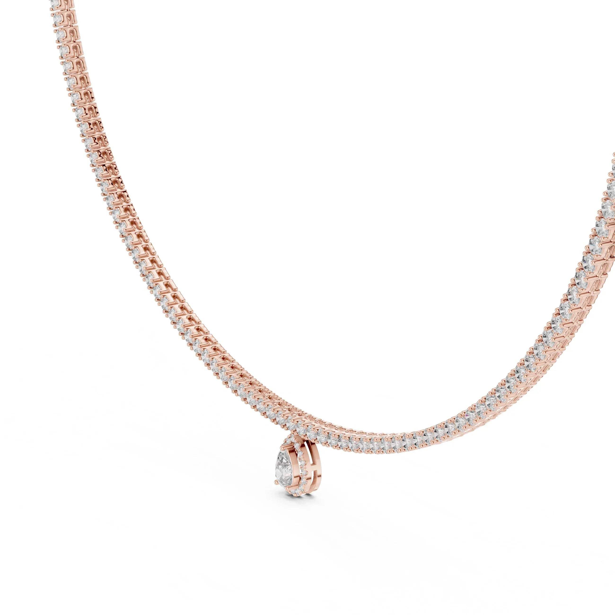 Gold and diamond tennis necklace with a small pear shape diamond pendant on a white background