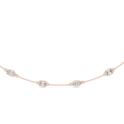 Rose gold necklace with diamond accents on a white background
