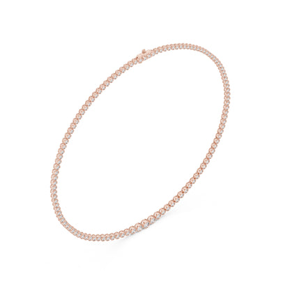 Rose gold tennis necklace with real diamonds in bezel setting on a white background.