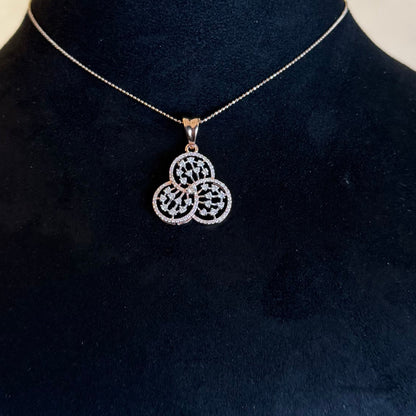 A gold diamond pendant with a floral design, displayed on a black mannequin necklace stand.