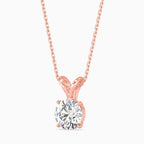 Rose gold necklace with a solitaire diamond pendant on a white background