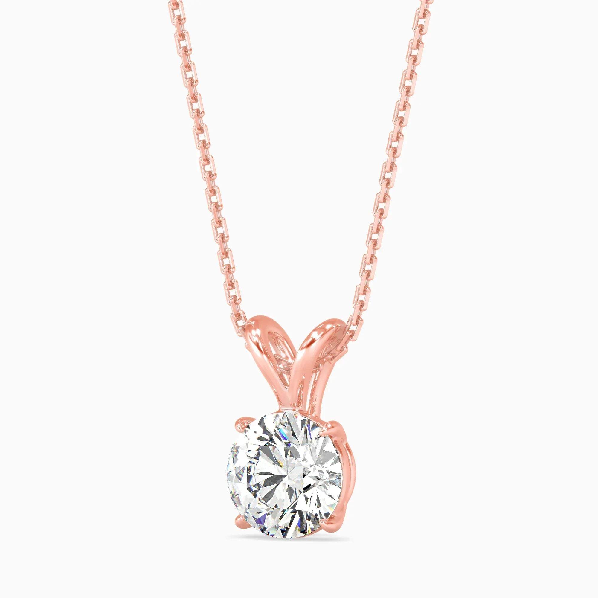 Rose gold necklace with a solitaire diamond pendant on a white background