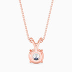 Rose gold necklace with a round diamond pendant on a white background