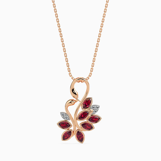 Rose gold diamond necklace with a leaf-shaped pendant featuring ruby gemstones on a white background