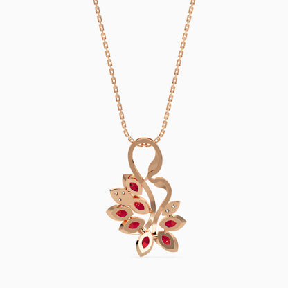 Rose gold necklace with a floral pendant featuring red stones on a white background