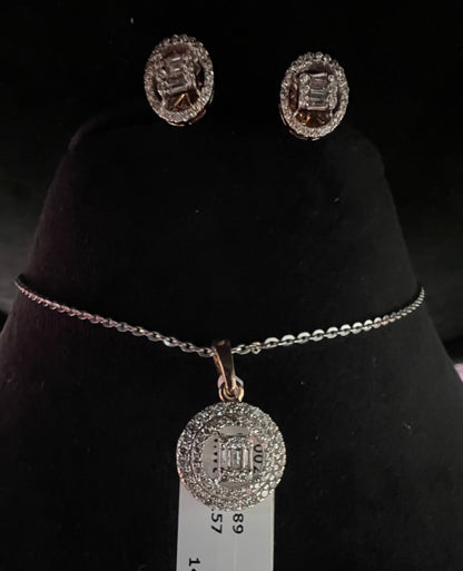 A mannequin showcasing a gold diamond pendant and earrings set, with the pendant hanging from a chain and the earrings displayed above.