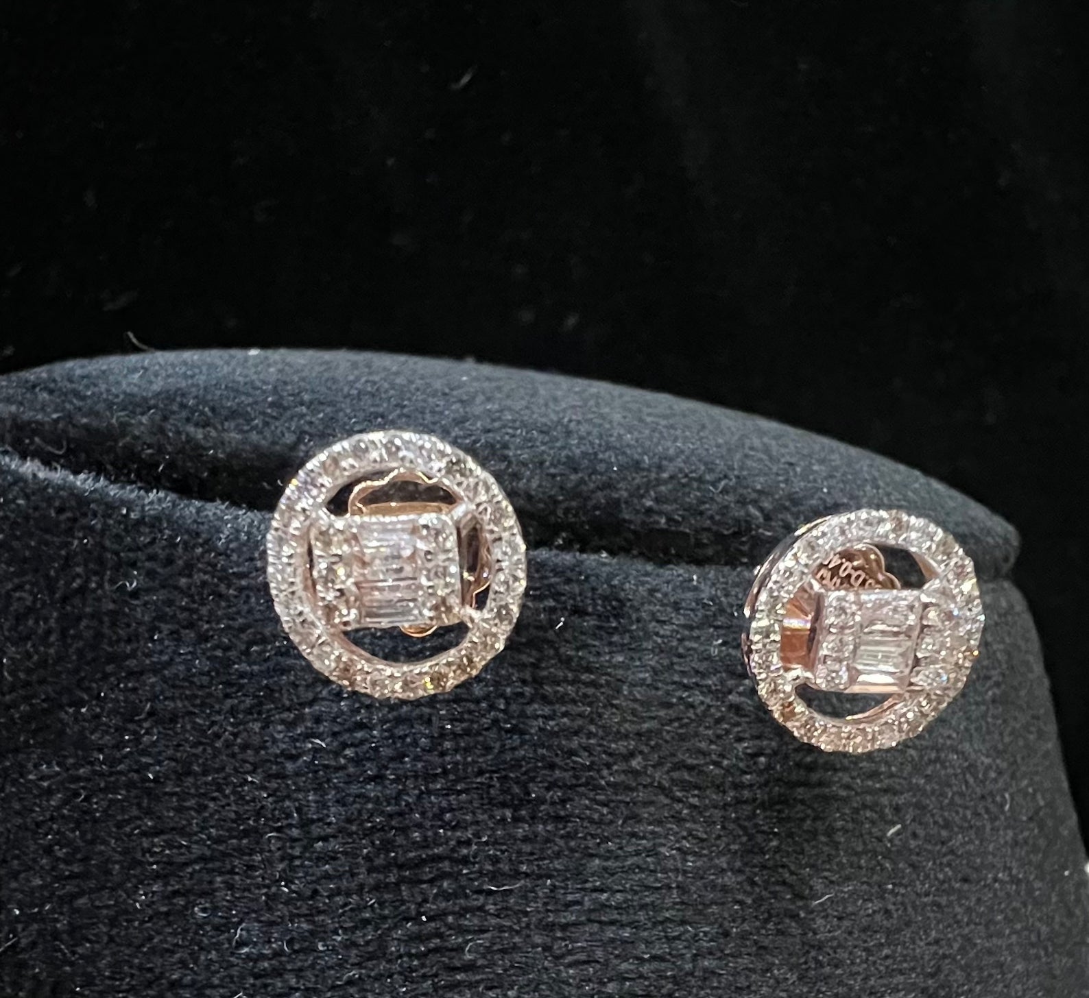 A mannequin showcasing a gold diamond earrings displayed.