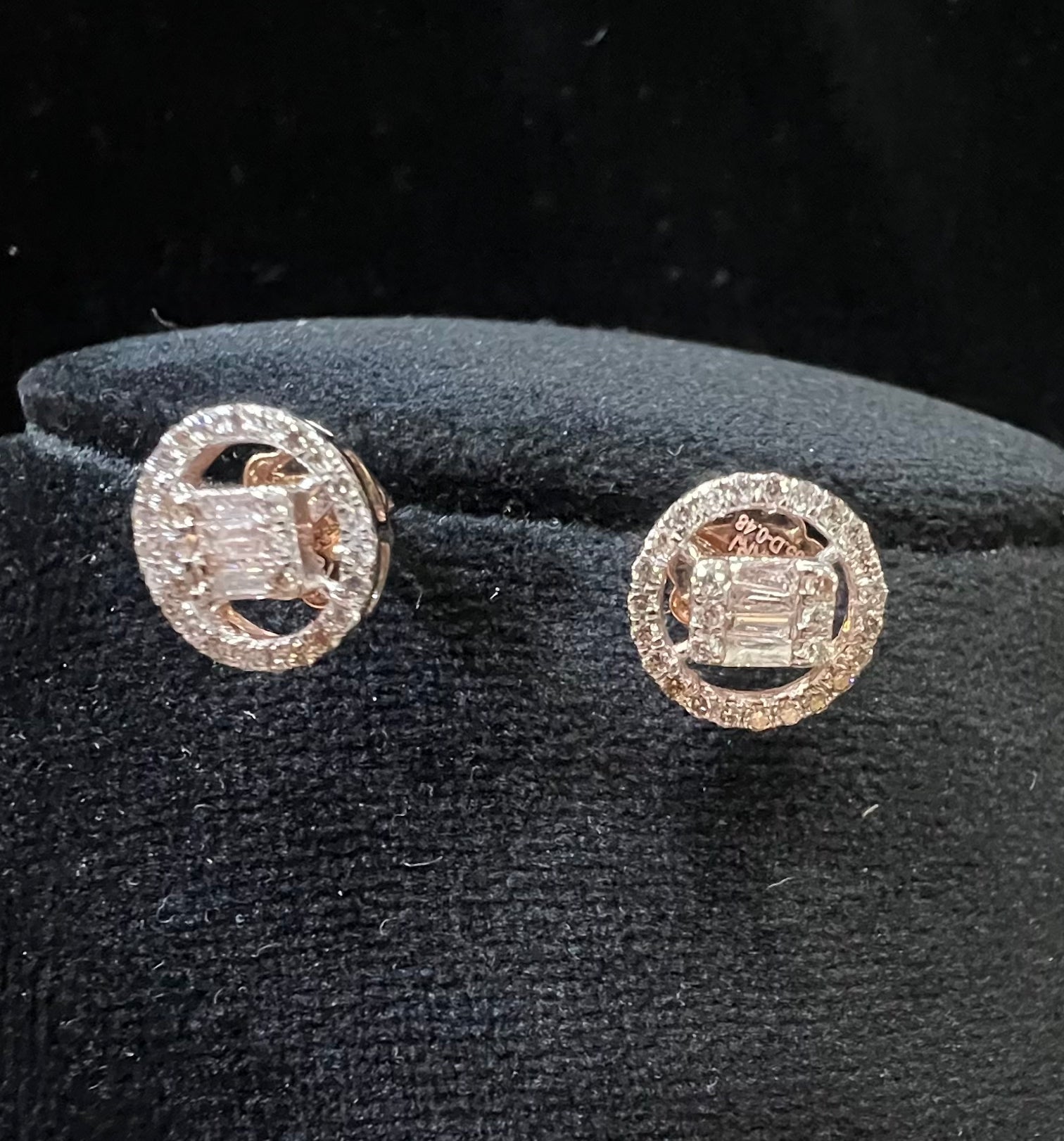 A mannequin showcasing a gold diamond earrings displayed.