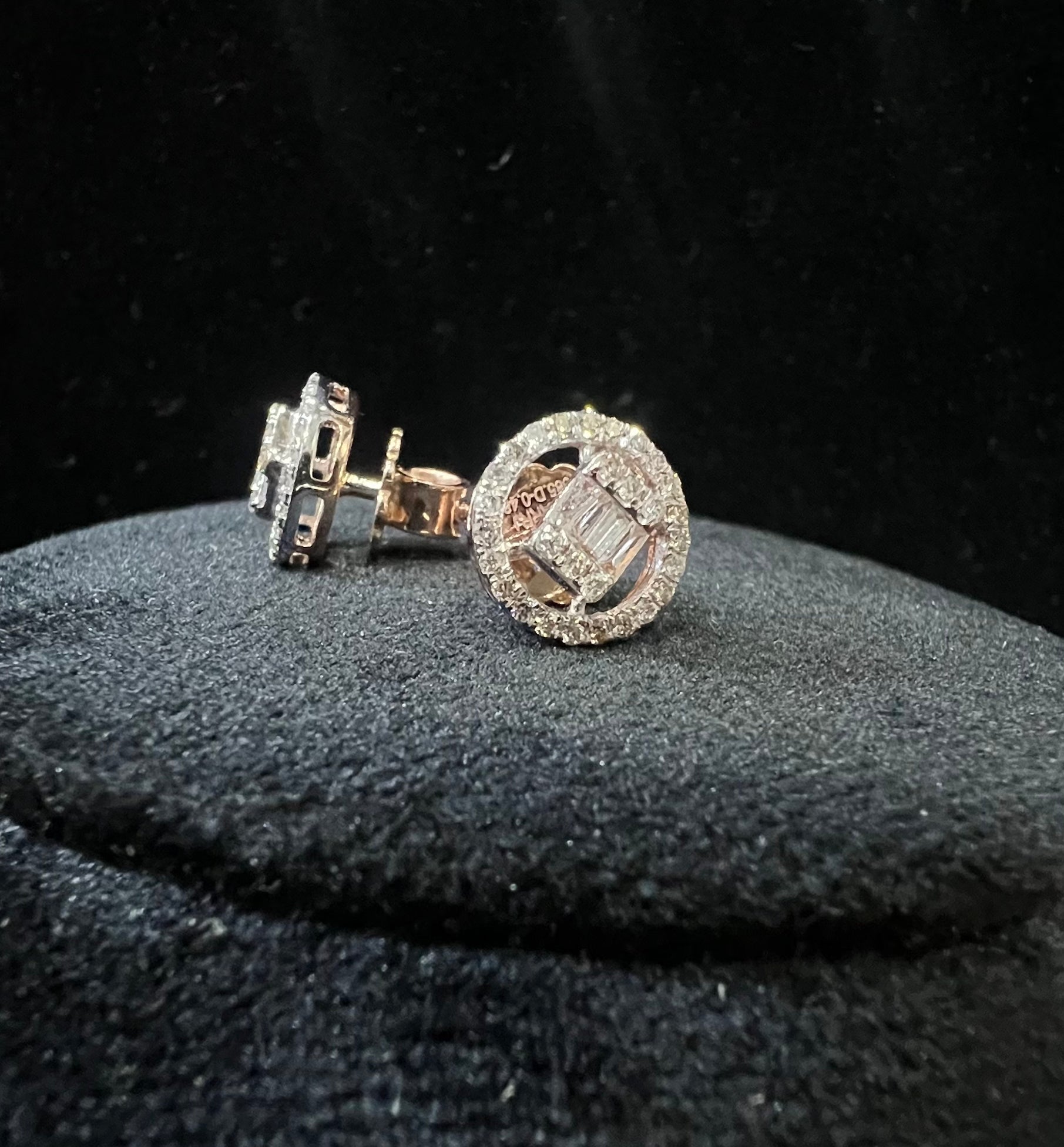 A mannequin showcasing gold diamond earrings displayed.