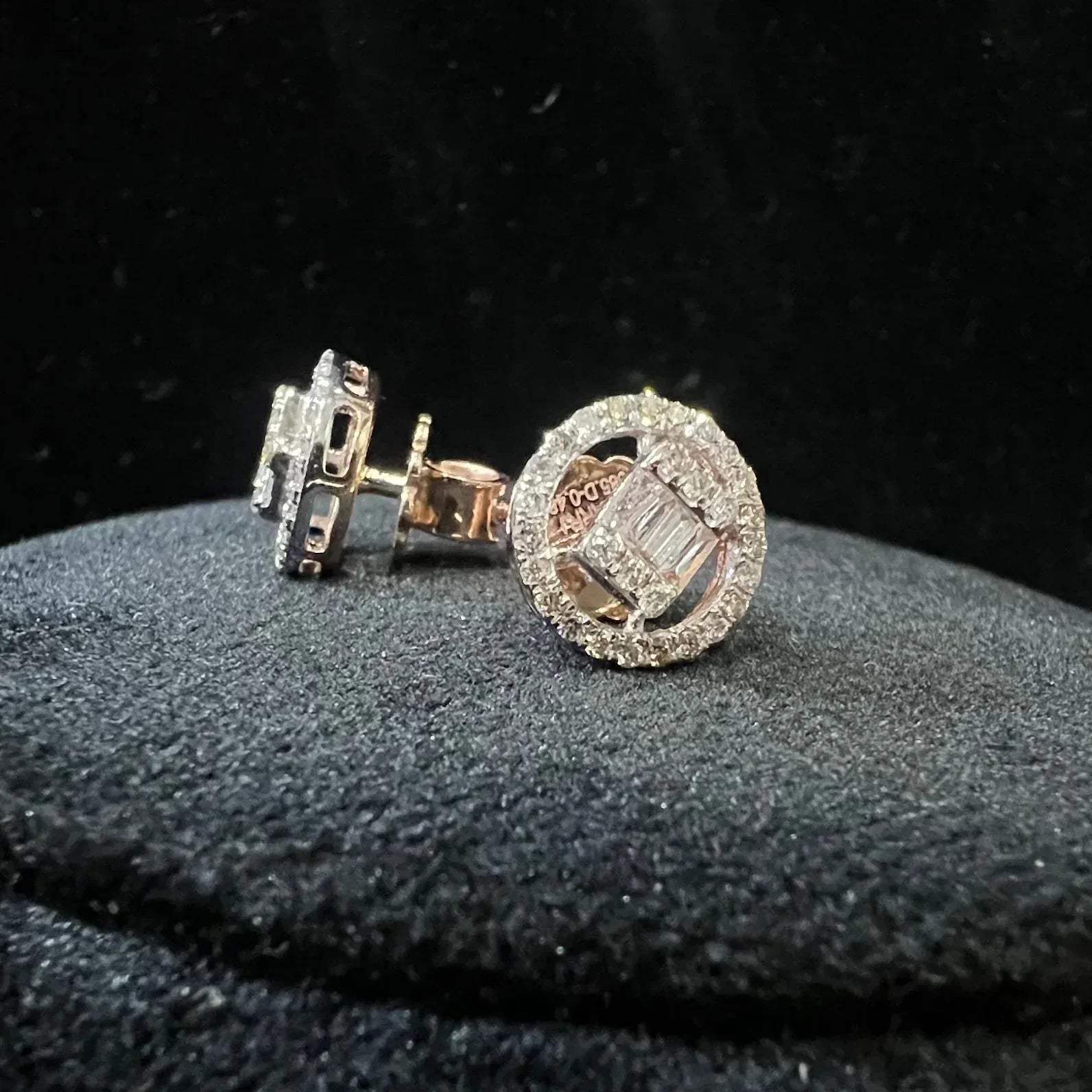 A mannequin showcasing gold diamond earrings displayed.