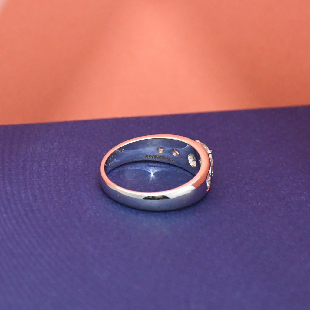 White gold ring with real diamonds on a blue surface