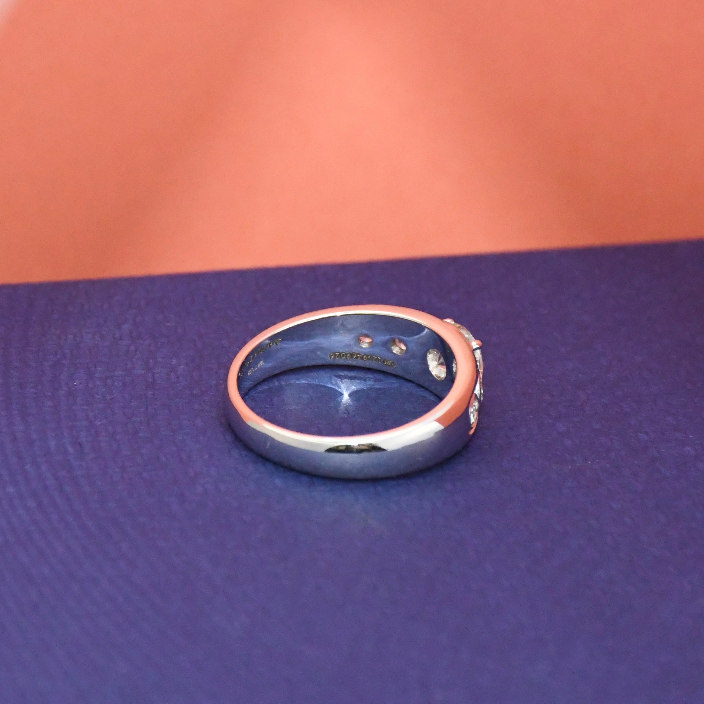 White gold ring with real diamonds on a blue surface