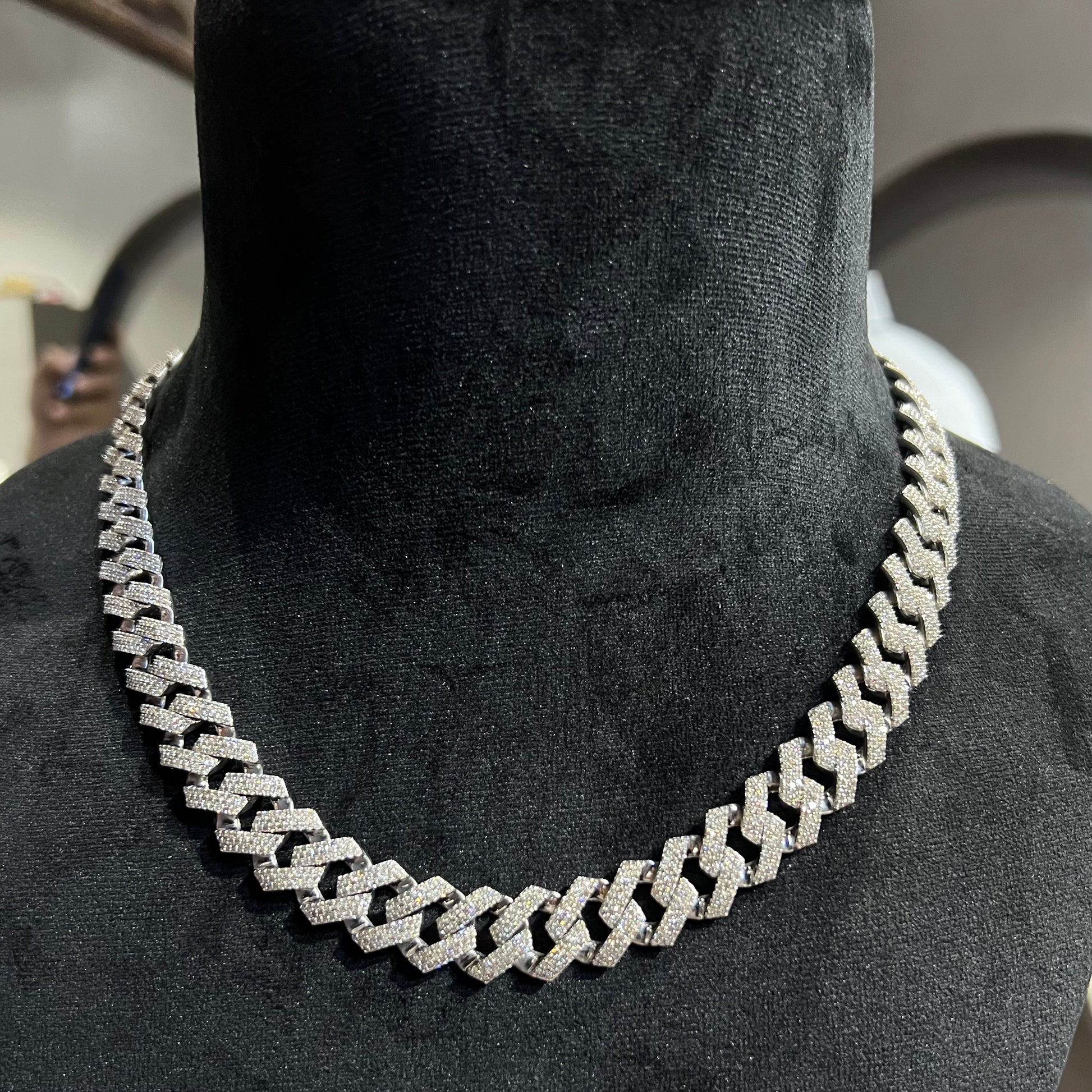 Luxury gold Cuban chain necklace with pavé-set diamonds and bold interlocking links for a stylish statement look.