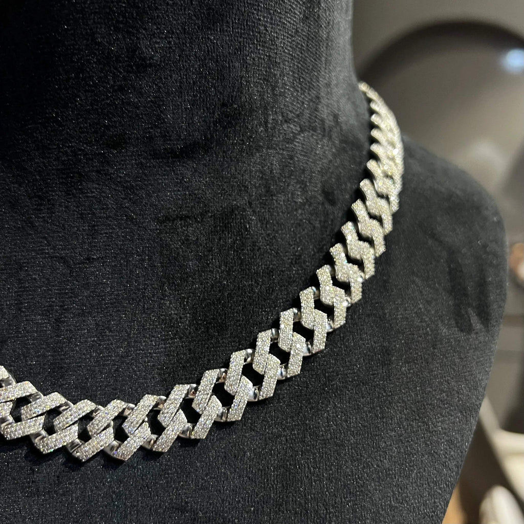 Luxury gold Cuban chain necklace with pavé-set diamonds and bold interlocking links for a stylish statement look.