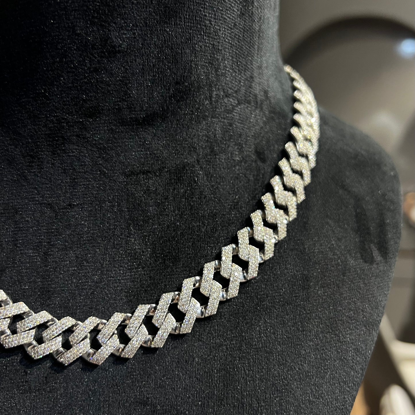 Luxury gold Cuban chain necklace with pavé-set diamonds and bold interlocking links for a stylish statement look.
