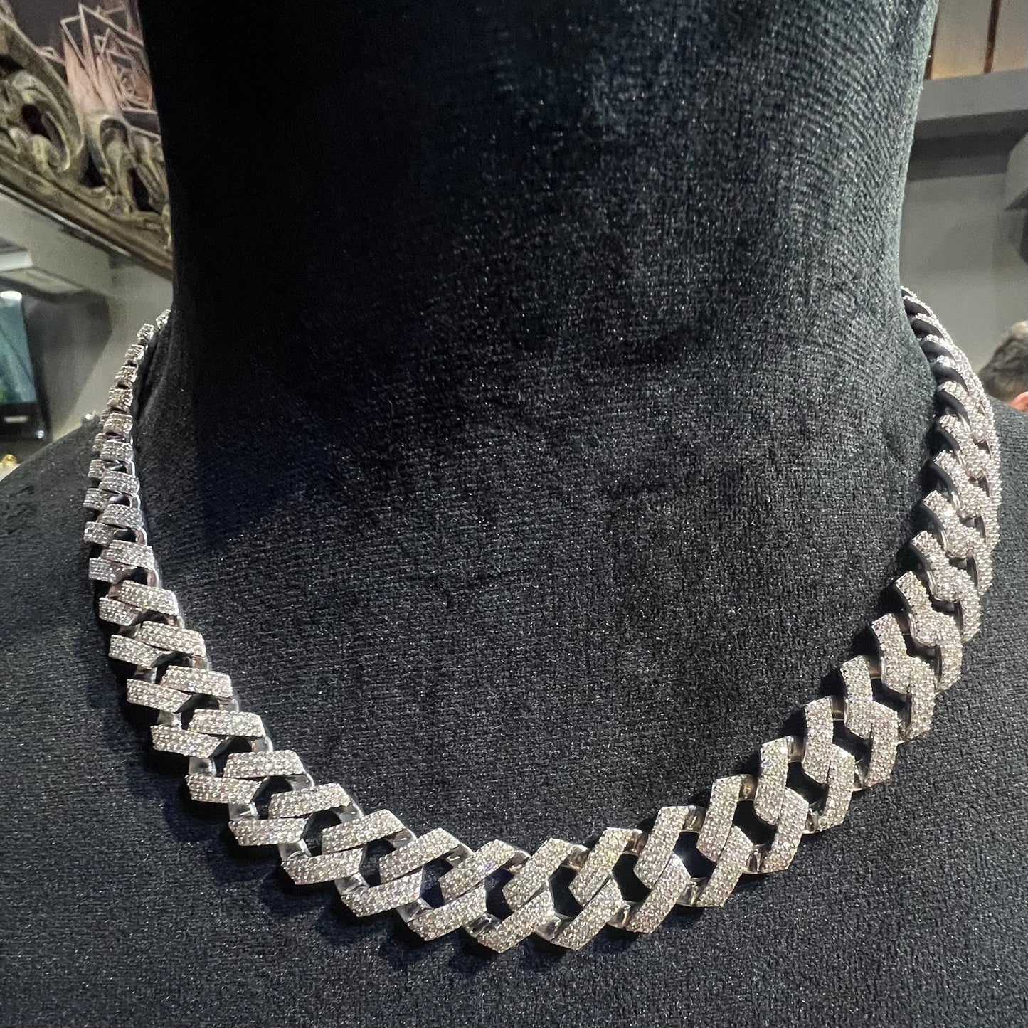 Luxury gold Cuban chain necklace with pavé-set diamonds and bold interlocking links for a stylish statement look.