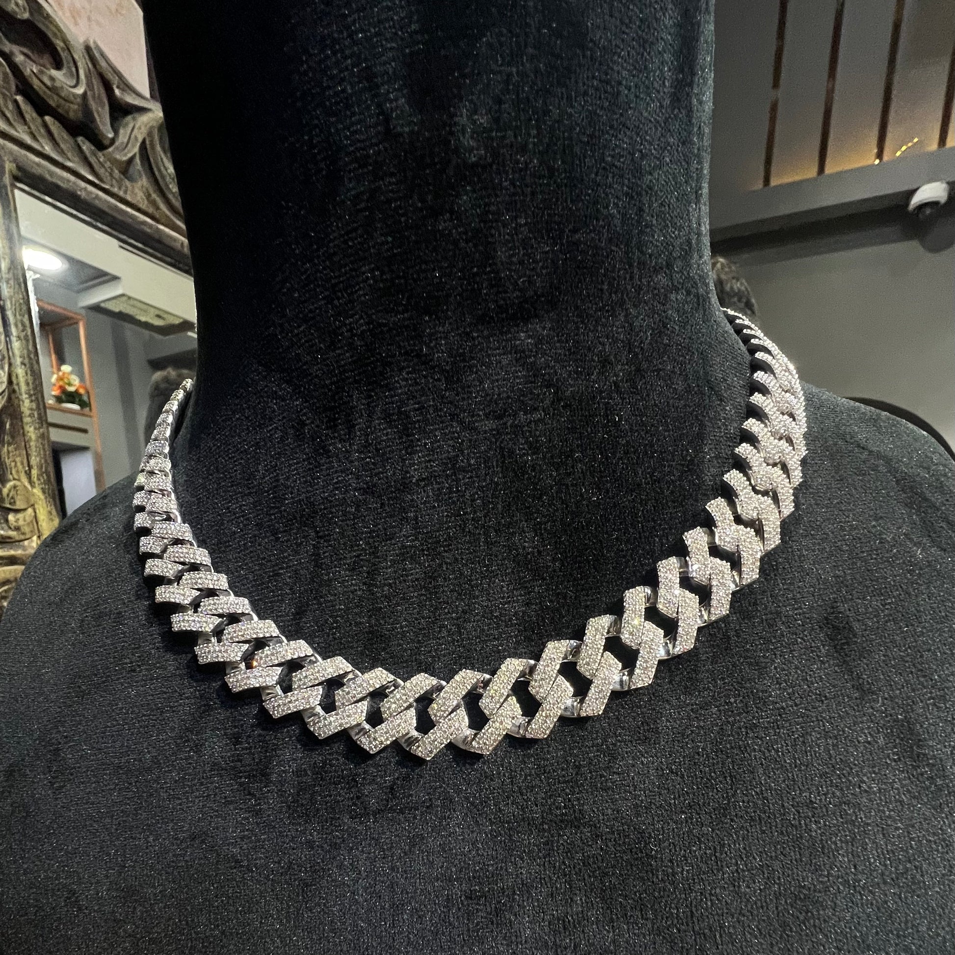 Luxury gold Cuban chain necklace with pavé-set diamonds and bold interlocking links for a stylish statement look.
