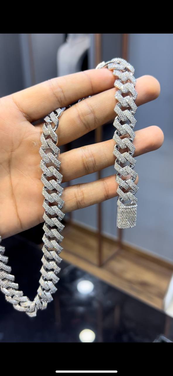 Luxury gold Cuban chain necklace with pavé-set diamonds and bold interlocking links for a stylish statement look.
