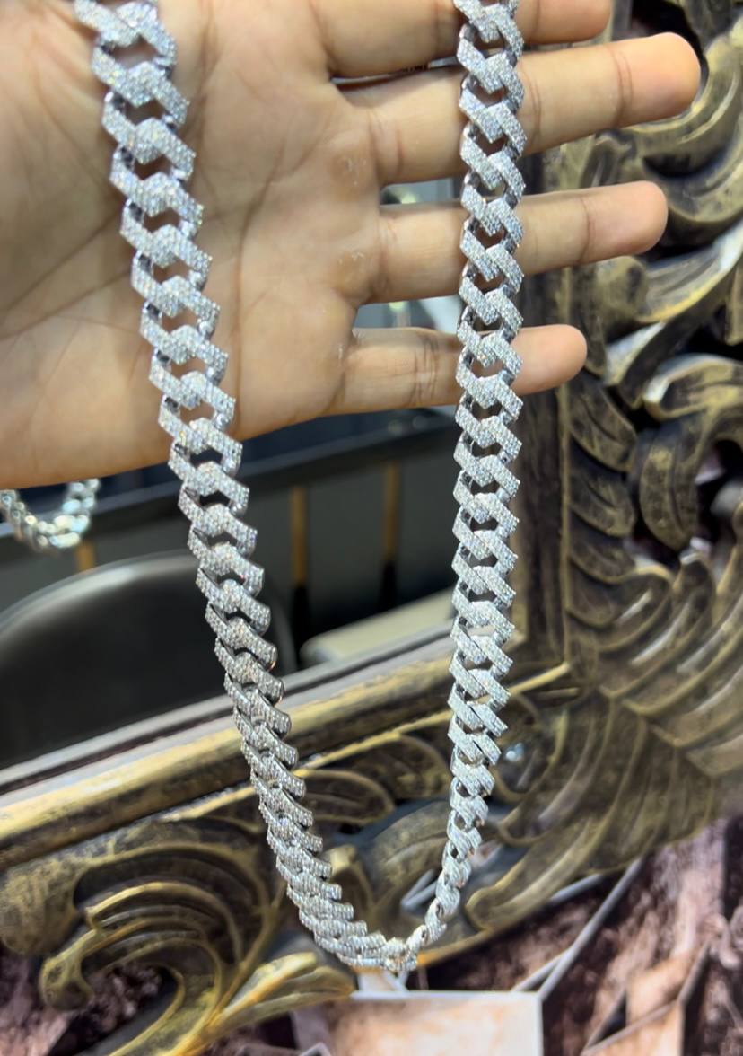 Luxury gold Cuban chain necklace with pavé-set diamonds and bold interlocking links for a stylish statement look.