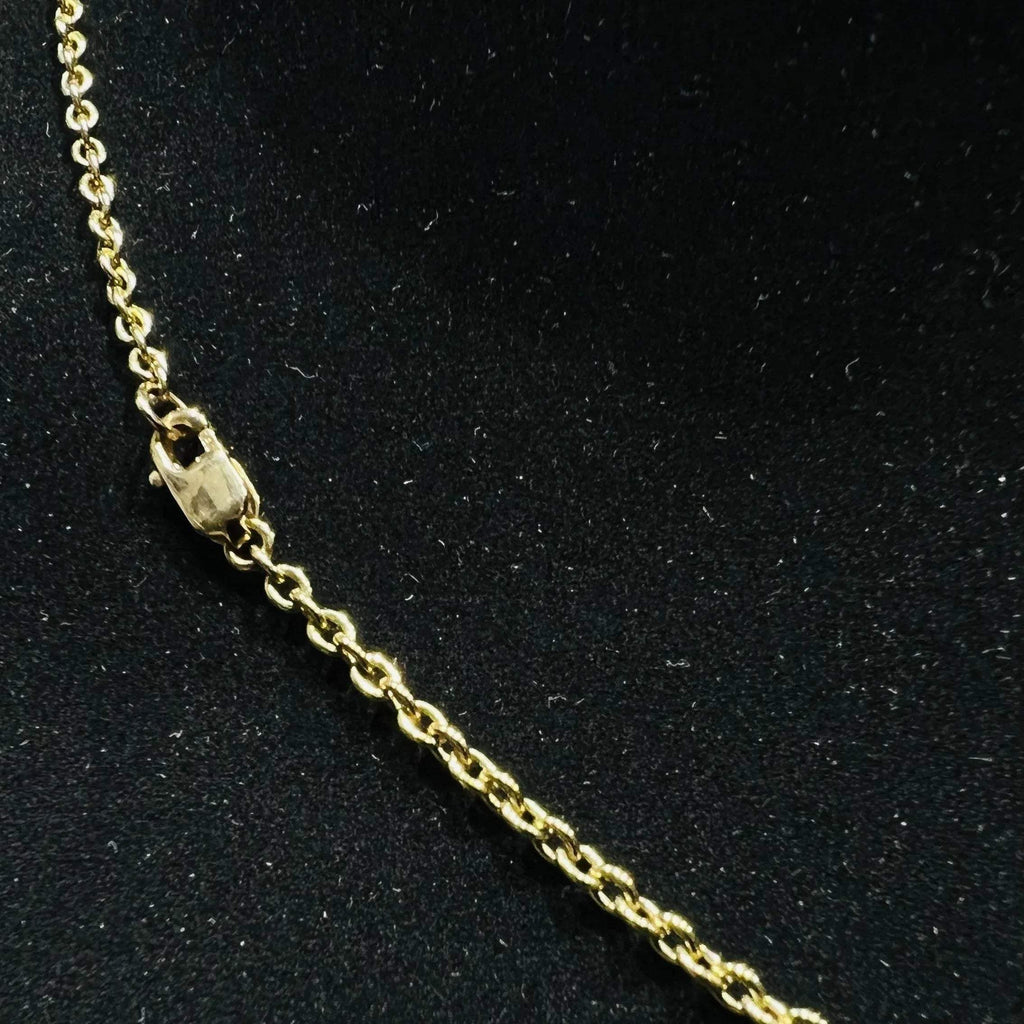 A stylish gold diamond beaded mangalsutra with seven round bezel-set diamonds in a row, paired with small black beads on a delicate gold chain.