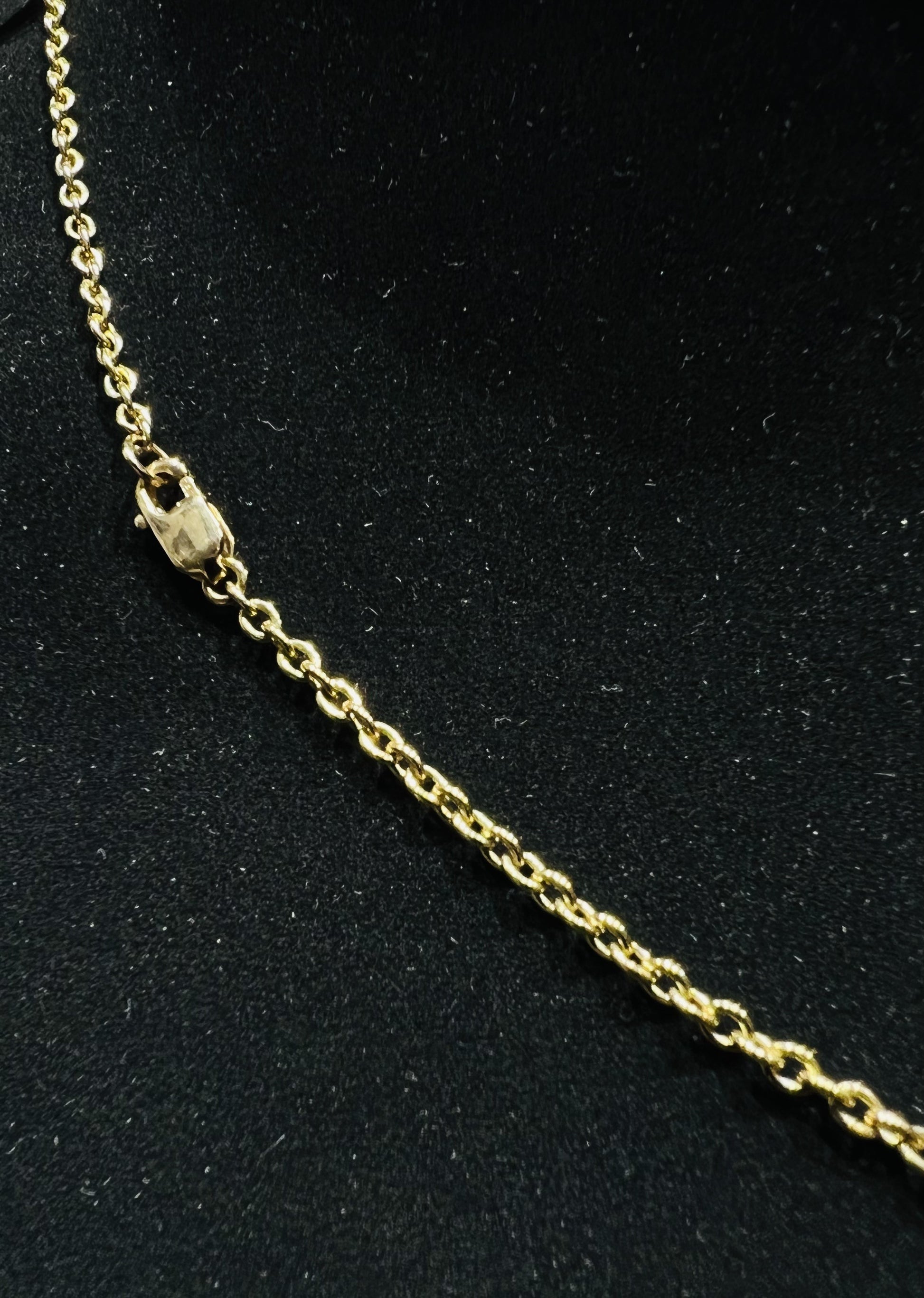A stylish gold diamond beaded mangalsutra with seven round bezel-set diamonds in a row, paired with small black beads on a delicate gold chain.