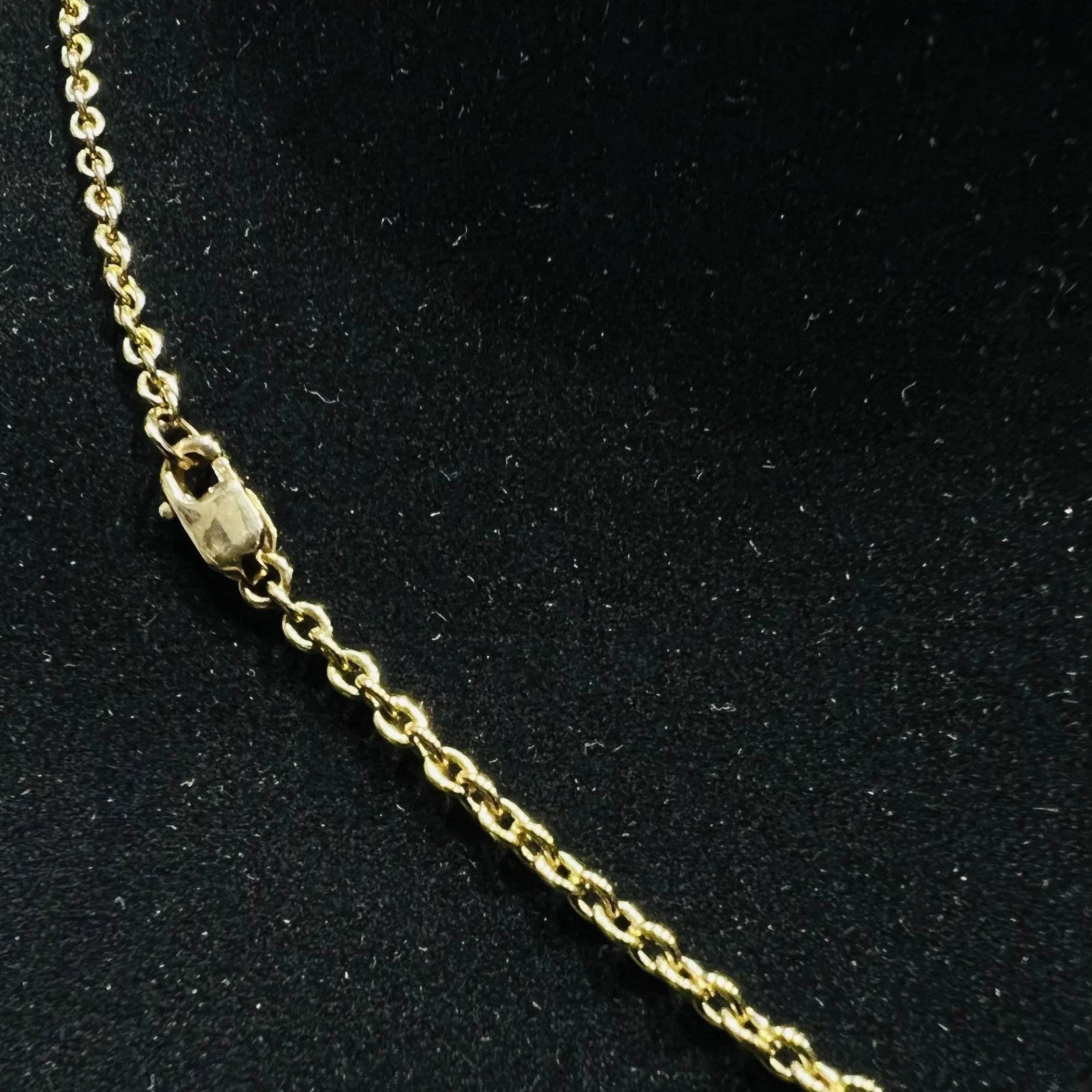 A stylish gold diamond beaded mangalsutra with seven round bezel-set diamonds in a row, paired with small black beads on a delicate gold chain.