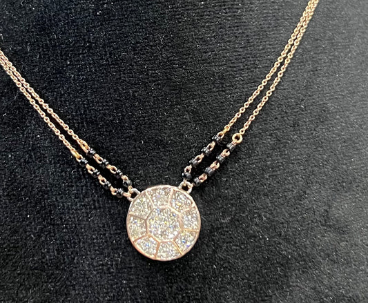 Elegant gold diamond mangalsutra with a circular diamond-studded pendant in honeycomb design, paired with black bead and gold chain for a modern traditional look.