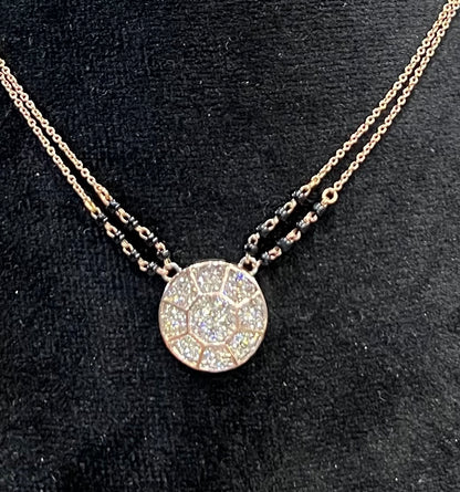 Elegant gold diamond mangalsutra with a circular diamond-studded pendant in honeycomb design, paired with black bead and gold chain for a modern traditional look.