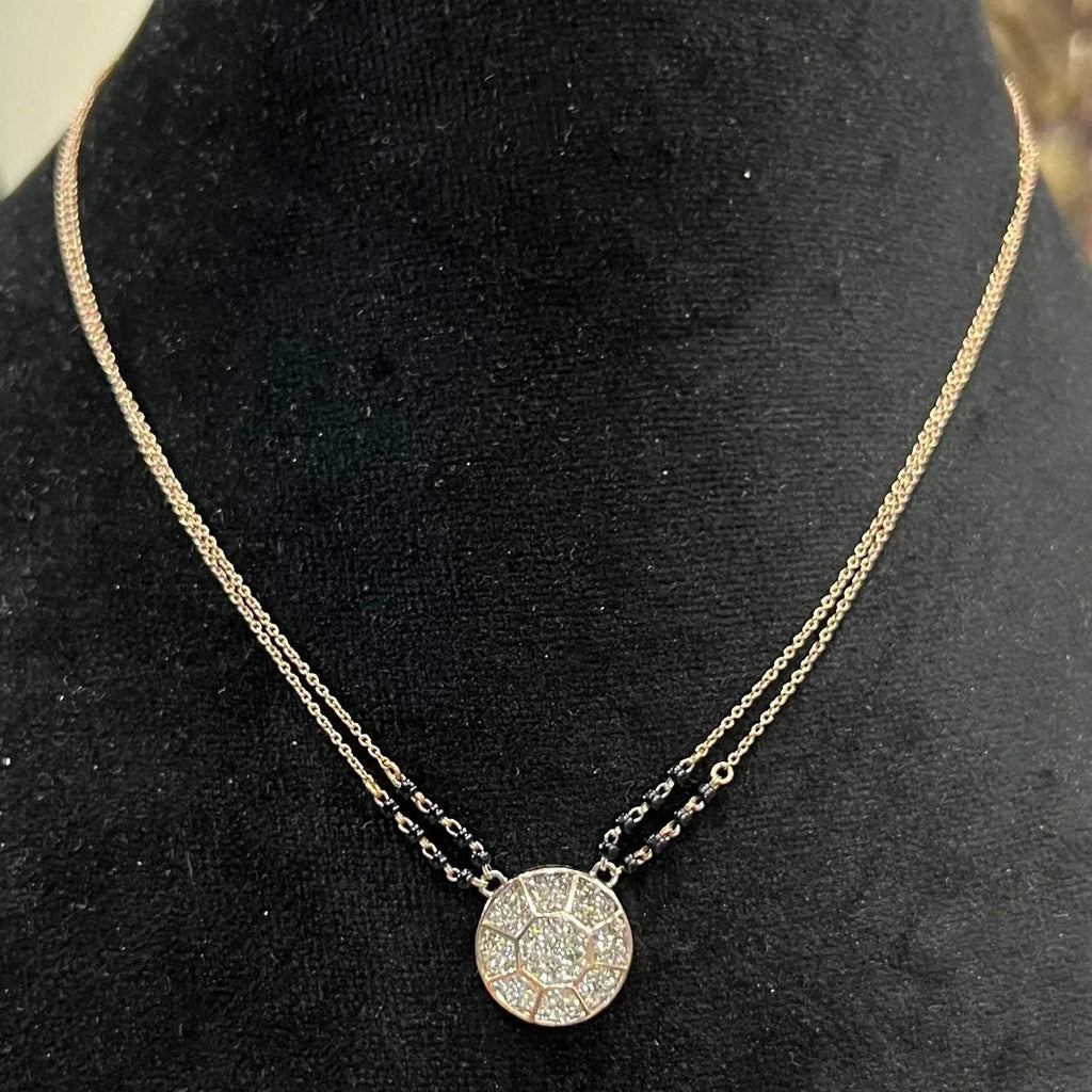 Elegant gold diamond mangalsutra with a circular diamond-studded pendant in honeycomb design, paired with black bead and gold chain for a modern traditional look.