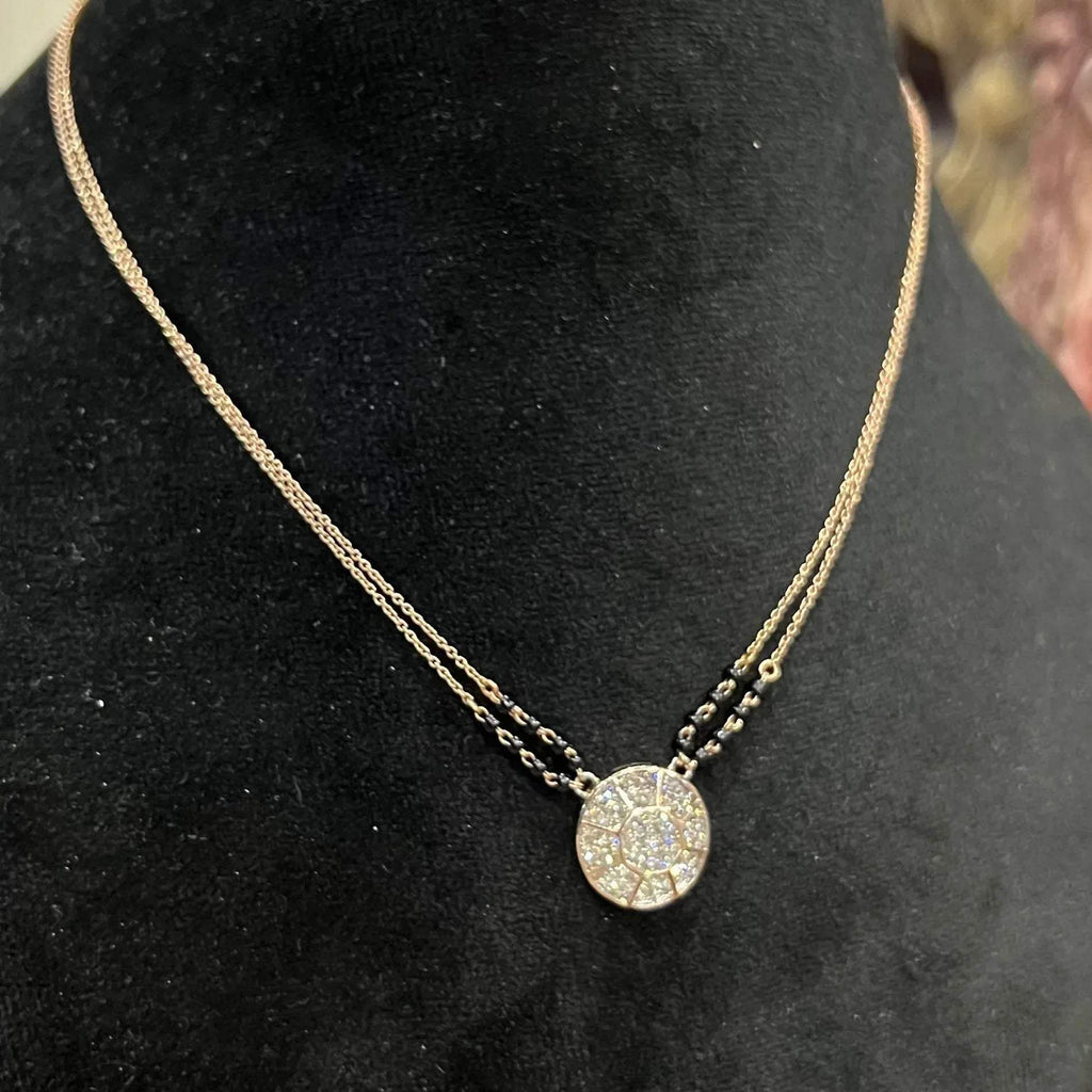 Elegant gold diamond mangalsutra with a circular diamond-studded pendant in honeycomb design, paired with black bead and gold chain for a modern traditional look.