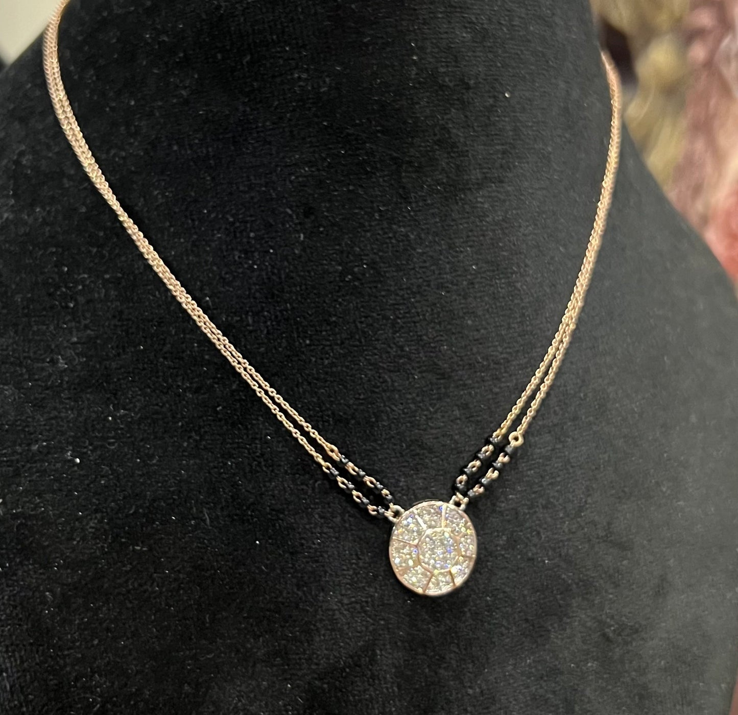 Elegant gold diamond mangalsutra with a circular diamond-studded pendant in honeycomb design, paired with black bead and gold chain for a modern traditional look.