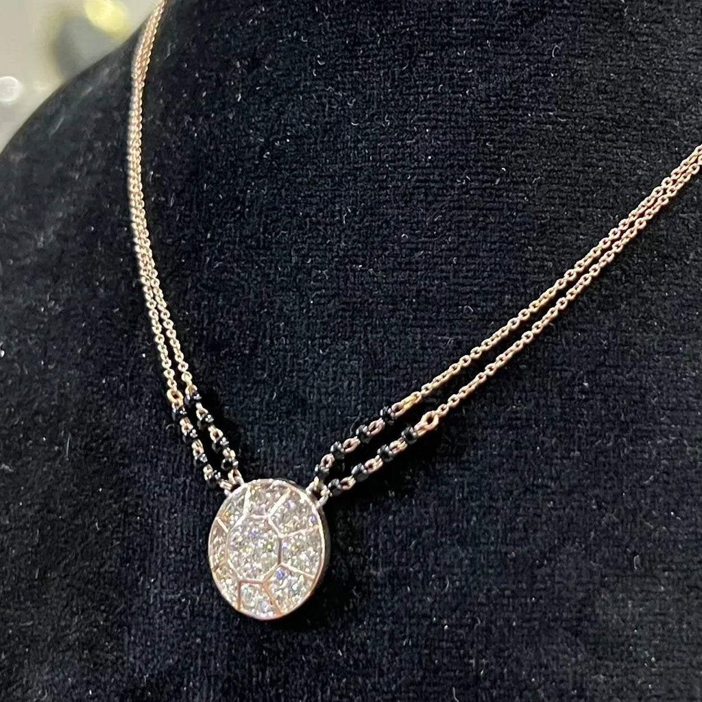 Elegant gold diamond mangalsutra with a circular diamond-studded pendant in honeycomb design, paired with black bead and gold chain for a modern traditional look.