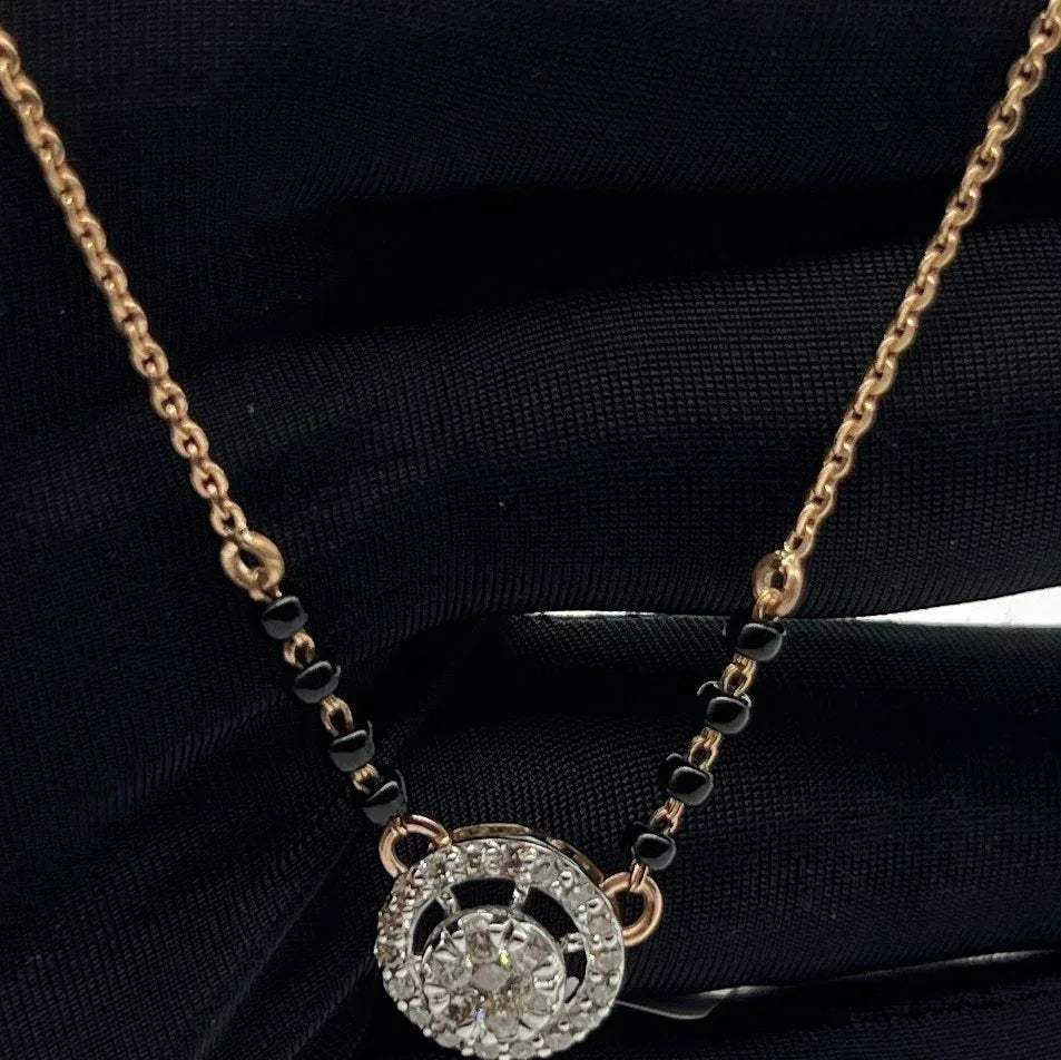 Elegant gold diamond mangalsutra with round halo diamond pendant and dual black bead gold chain, perfect for daily wear and modern bridal style.