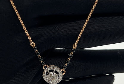 Elegant gold diamond mangalsutra with round halo diamond pendant and dual black bead gold chain, perfect for daily wear and modern bridal style.