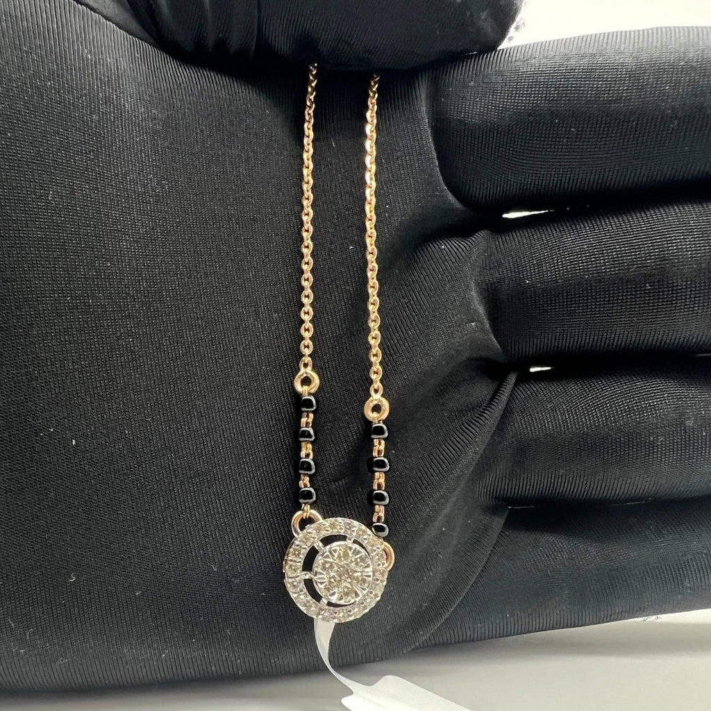 Elegant gold diamond mangalsutra with round halo diamond pendant and dual black bead gold chain, perfect for daily wear and modern bridal style.