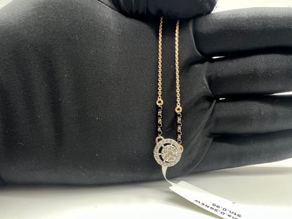 Elegant gold diamond mangalsutra with round halo diamond pendant and dual black bead gold chain, perfect for daily wear and modern bridal style.
