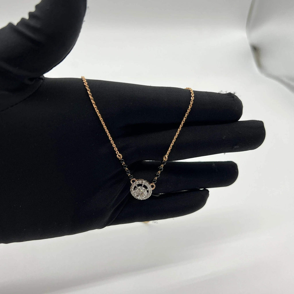 Elegant gold diamond mangalsutra with round halo diamond pendant and dual black bead gold chain, perfect for daily wear and modern bridal style.