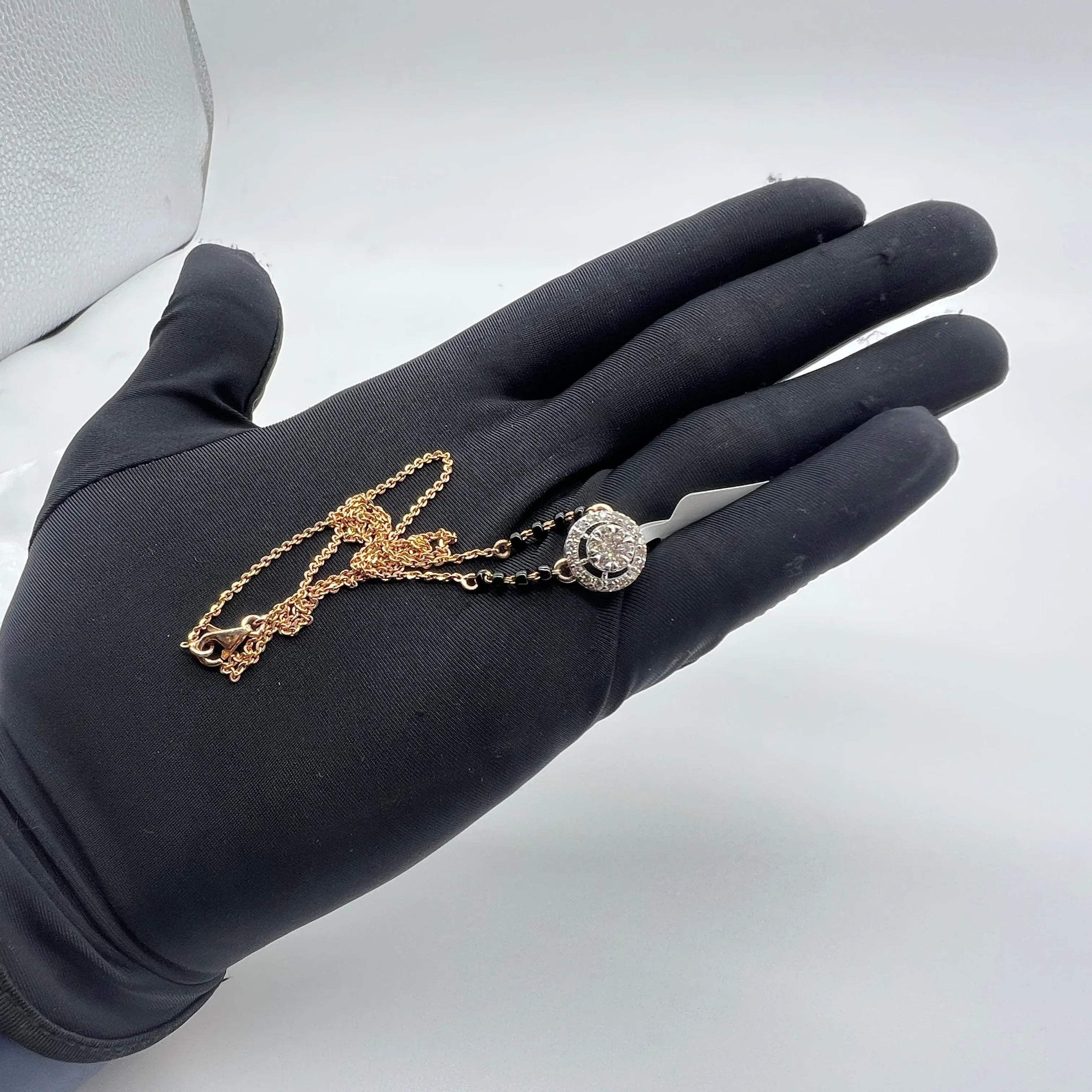 Elegant gold diamond mangalsutra with round halo diamond pendant and dual black bead gold chain, perfect for daily wear and modern bridal style.