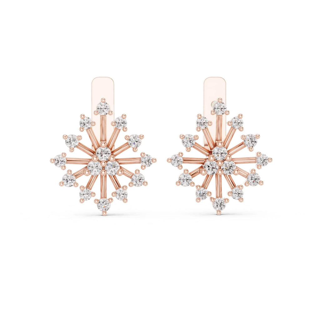 Rose gold and lab grown diamond snowflake earrings on a white background